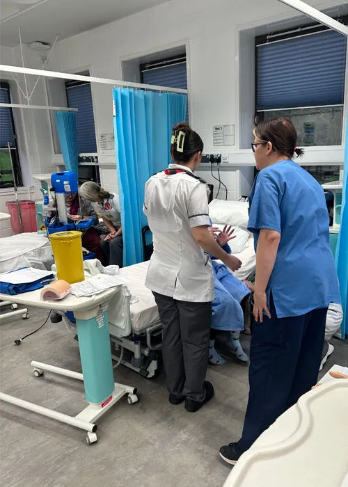 Nurses are engaging in a medical simulation in the University ward