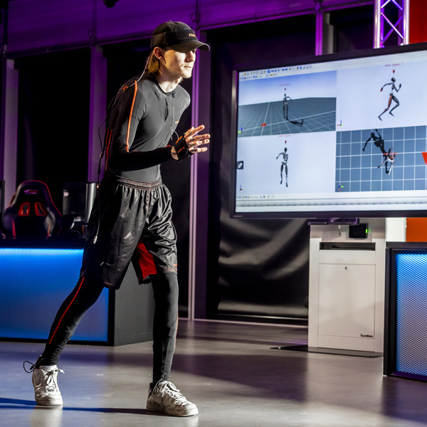 A male student is using the visual and motion equipment in the gaming studio