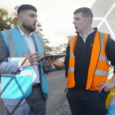 Two people in high-vis having a discussion