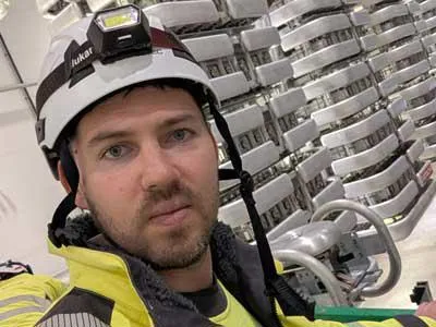 Man in a hard hat and hi vis jacket in an engineering environment