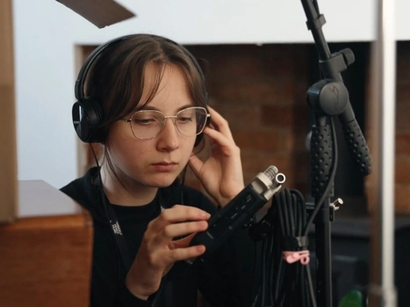 Woman wearing headphones checking sound levels