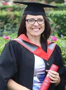 Cathryn Hurd holding a degree scroll