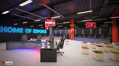 Empty gaming arena with rows of computers and a glowing sign reading 'HOME OF ESPORTS.'