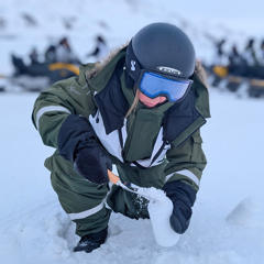 Professor Gwinnett wearing cold weather gear collecting samples in the snow
