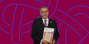 Ian Davies MBE, pictured receiving his Biomedical Scientist of the Year Award in 2023