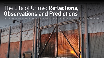 Lecture banner titled 'The Life of Crime: Reflections, Observations and Predictions' over a prison fence.