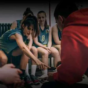 A female sports team pictured in a pre-match huddle