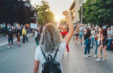 An image of a protester with their hand in the air