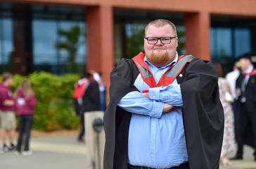 Rowan Simpson in his graduation cap and gown