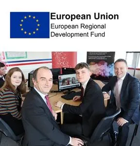 Adults and pupils gather around a computer beneath a European Union funding logo.