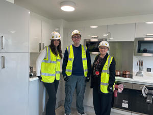 Students Lucy Hughes and Owen Ford with Christina Matthews during a site tour of the Student Village