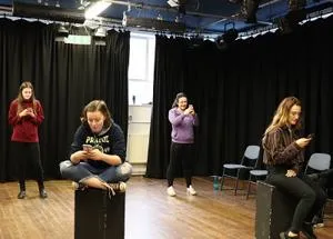 Students performing in a drama studio