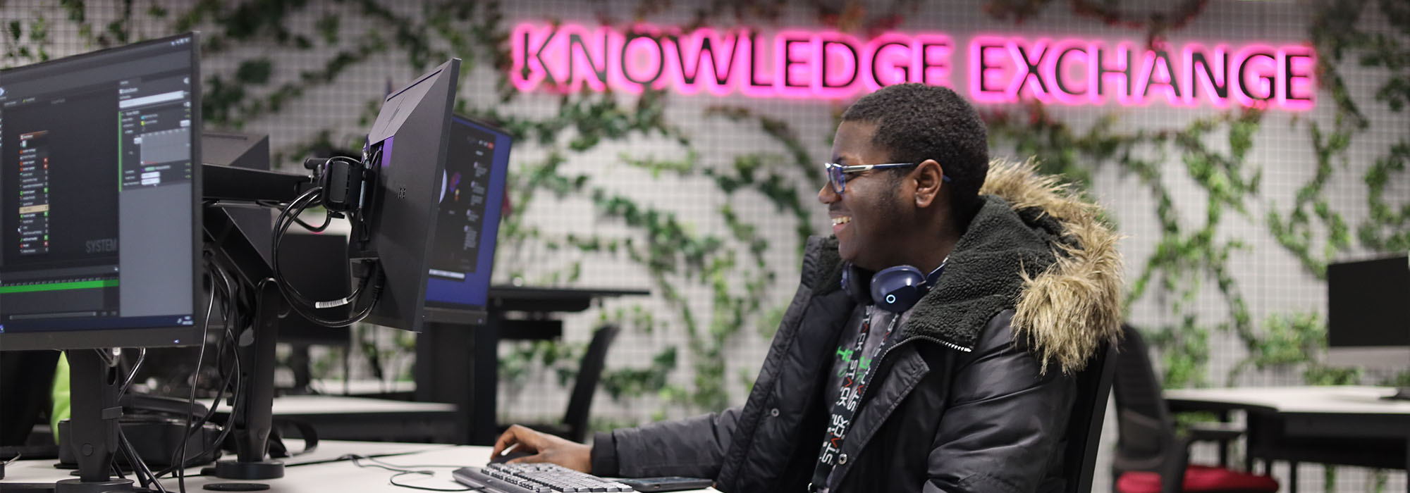Male student sitting at a desk in Knowledge Exchange